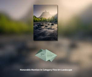 Scenic landscape with a mountain and river, featuring IPA 2023 Honorable Mention badge.