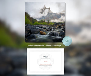 Mountain landscape with a river and trees, featuring an honorable mention badge for fine art landscape.